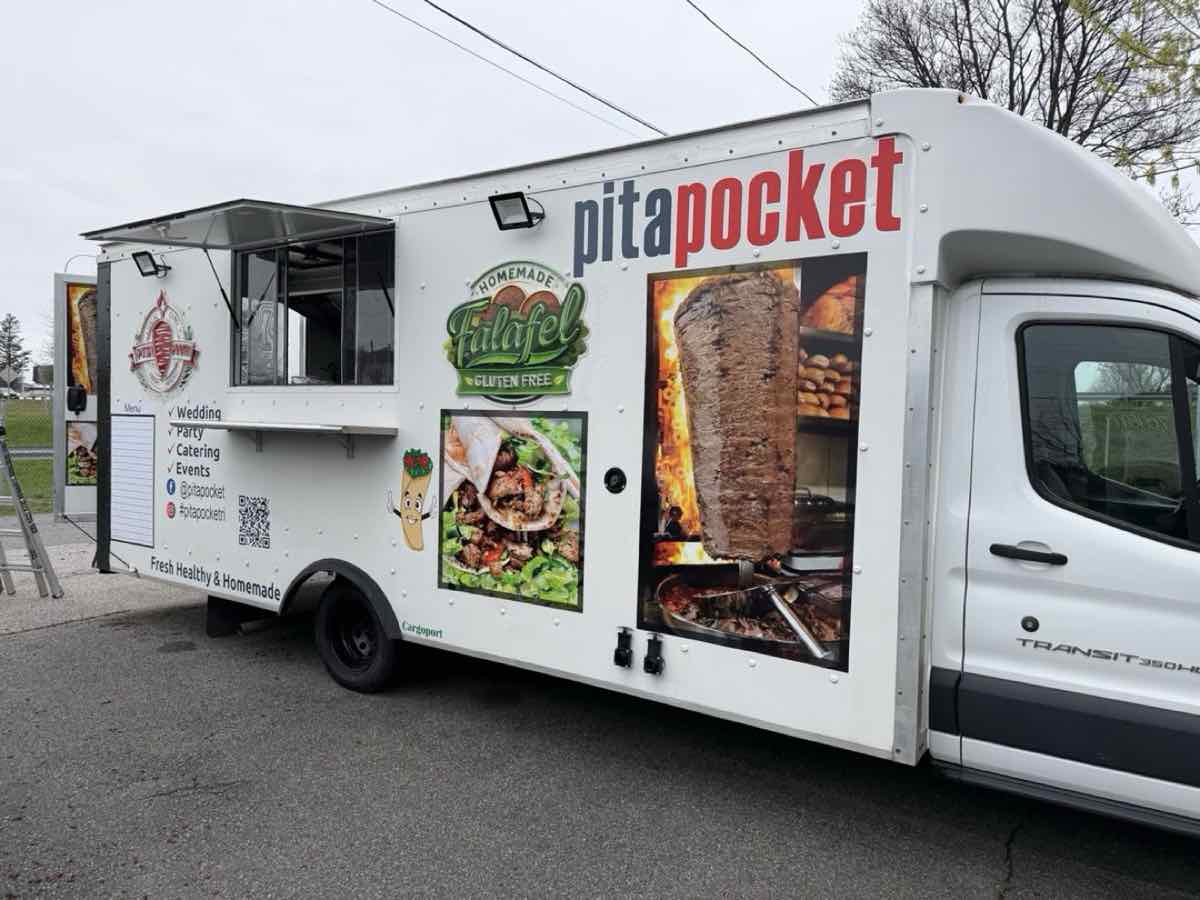 Pita Pocket food truck side view with menu and signage